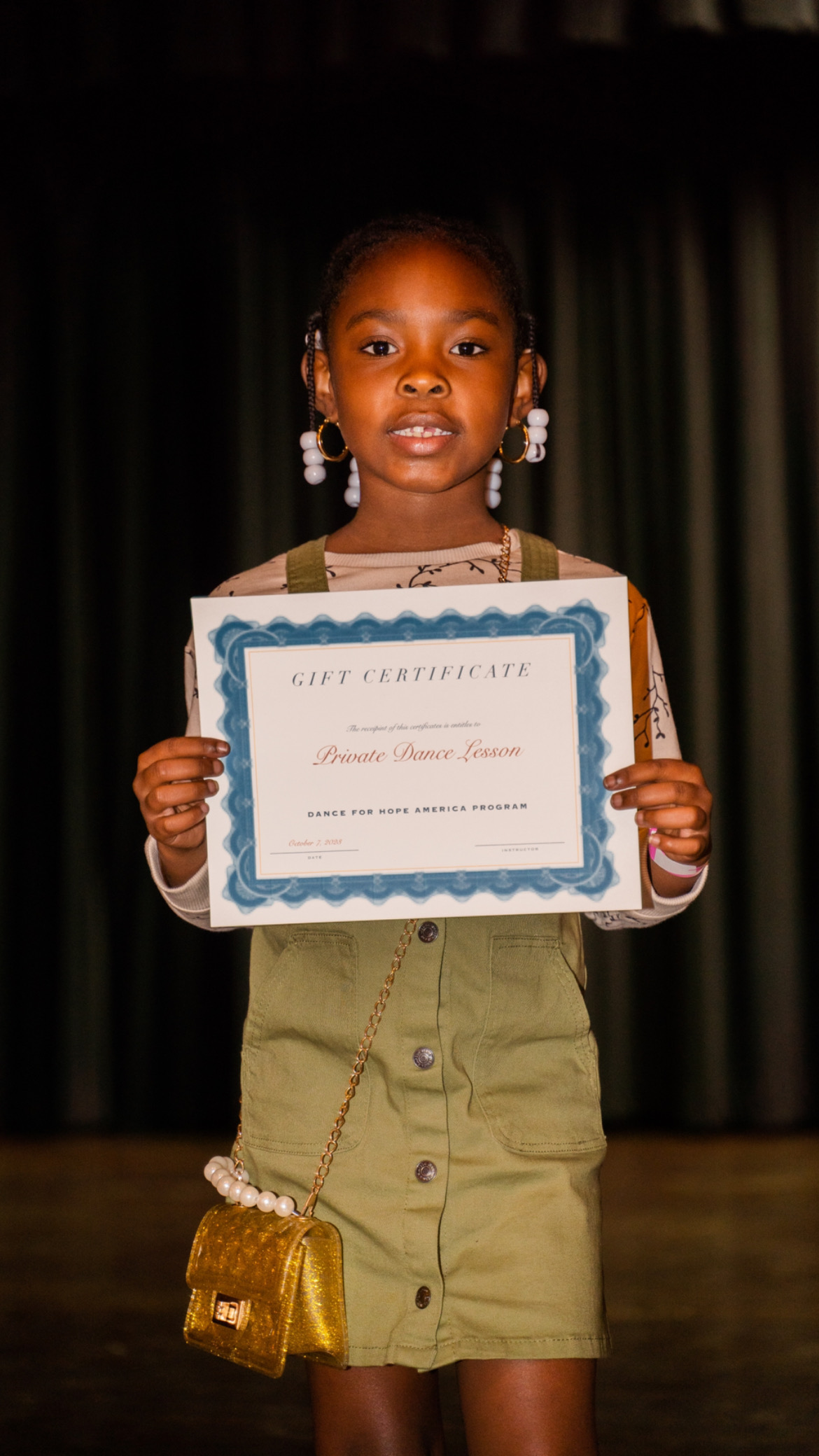 A young program participant with her certificate